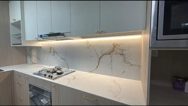 Galley kitchen with light timber cabinets and stone backsplash
