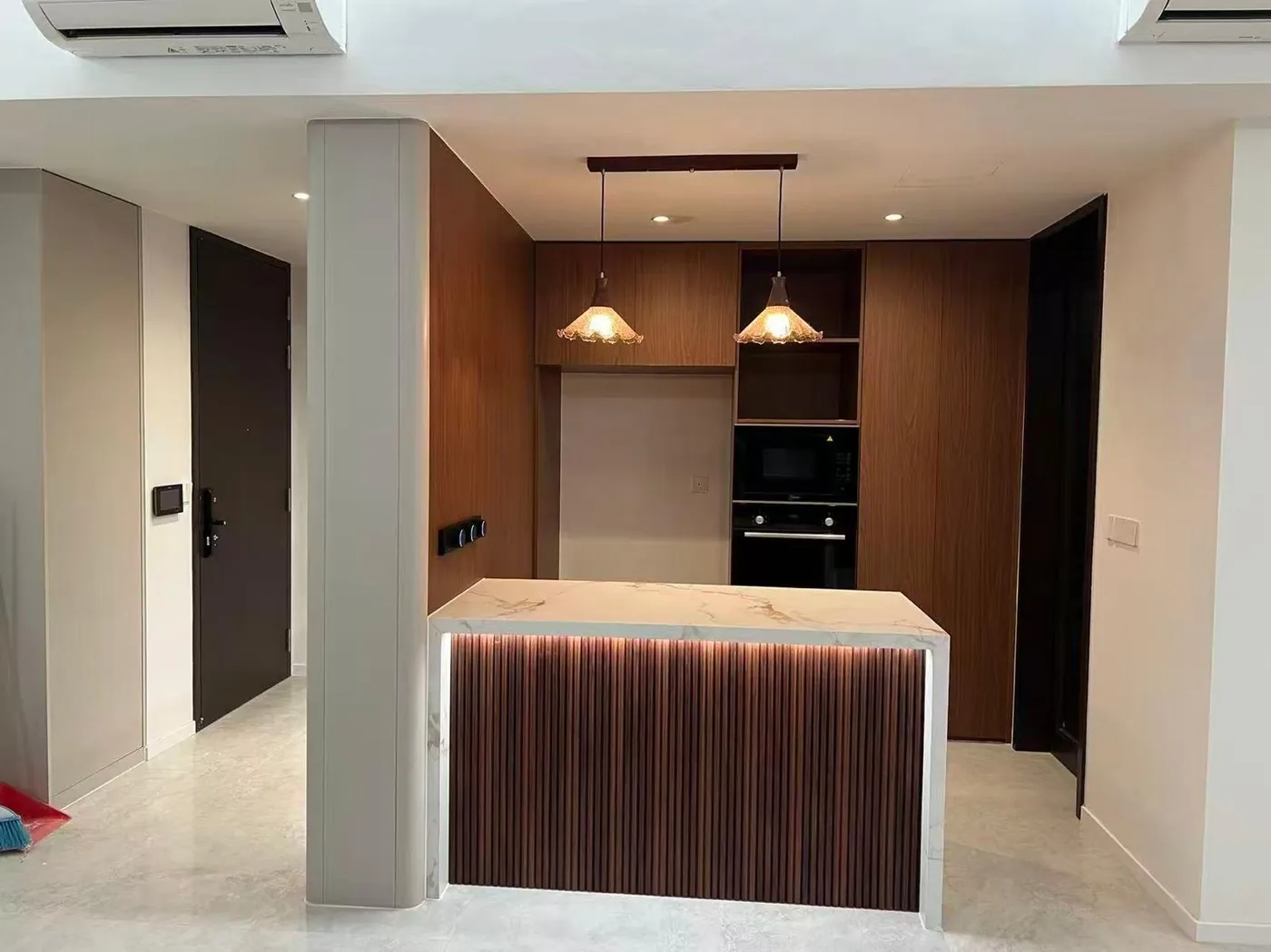 Completed kitchen island with fluted wood panels and marble top